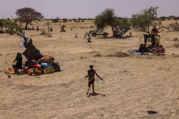 Refugees run for food in the Tine transit camp in Chad's Wadi Fara province on May 4, 2025. (AP Photo/Caitlin Kelly, File)