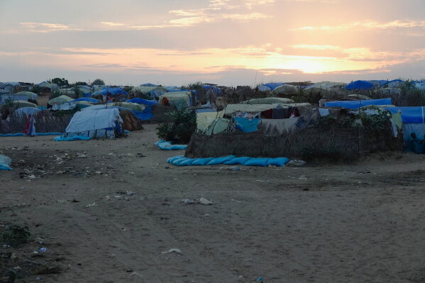 The sun sets on a refugee camp set up people fleeing war in Sudan, Oct. 3, 2024, in Adre, Chad. (AP Photo/Sam Mednick)