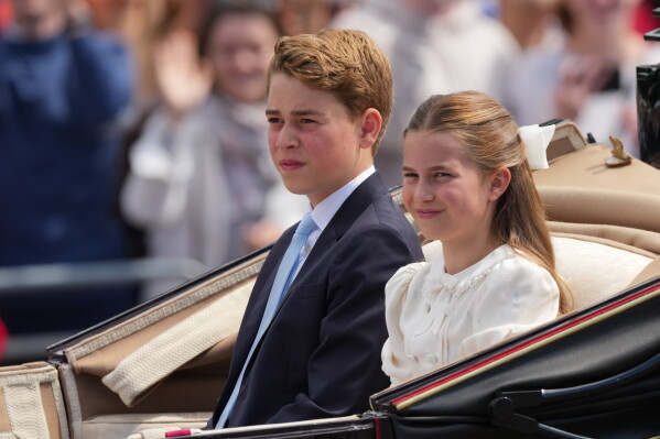 Britain's Prince George and Princess Charlotte ride on an open top carriage during Trooping The Colour, the King's annual birthday parade, in London, Saturday, June 13, 2026. (AP Photo/Kirsty Wigglesworth)