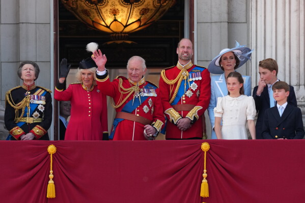 Britain's King Charles III, third left and Queen Camilla, second left wave to the crowds from the balcony of Buckingham Palace, with other members of the royal family, Princess Anne, left Prince William, Kate Princess of Wales, Princess Charlotte, Prince George and Prince Louis during Trooping The Colour, the King's annual birthday parade, in London, Saturday, June 13, 2026. (AP Photo/Kirsty Wigglesworth)
