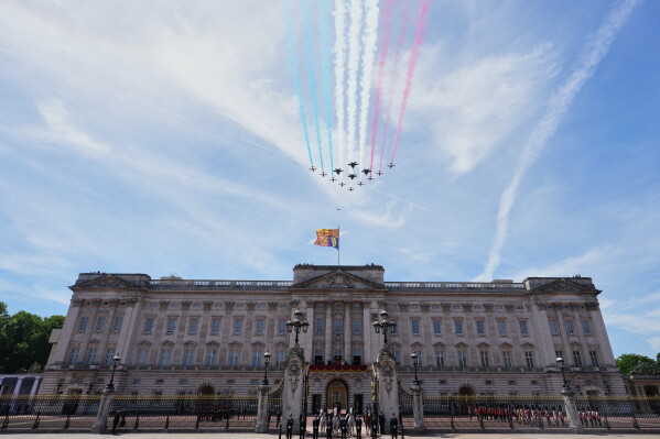 Plane of the Royal Air Force perform a flypast over Buckingham Palace, watched by members of the British family including King Charles III, during Trooping The Colour, the King's annual birthday parade, in London, Saturday, June 13, 2026. (AP Photo/Kirsty Wigglesworth)