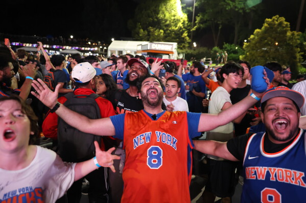 New York Knicks fans celebrate during a watch party inside Central Park after the Knicks won Game 4 of the NBA Finals basketball series against the San Antonio Spurs, Wednesday, June 10, 2026, in New York. (AP Photo/Heather Khalifa)