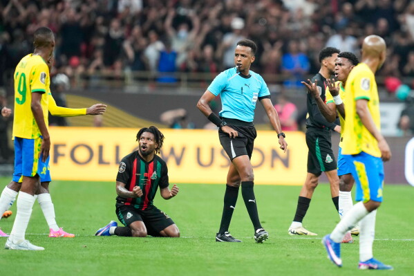 Referee Omar Artan, center, of Somalia, signals a penalty during the CAF Champions League final soccer match between AS FAR Rabat and Mamelodi Sundowns, in Rabat, Morocco, Sunday, May 24, 2026. (AP Photo/Mosa'ab Elshamy)