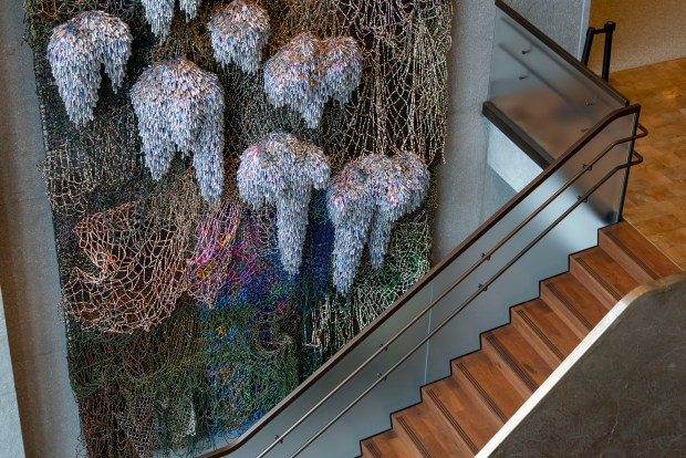 Nick Cave and Marie Watt's artwork "This Land, Shared Sky" next to a staircase in the lobby at the Obama Presidential Center, June 8, 2026, in Chicago's Jackson Park. (Brian Cassella/Chicago Tribune)