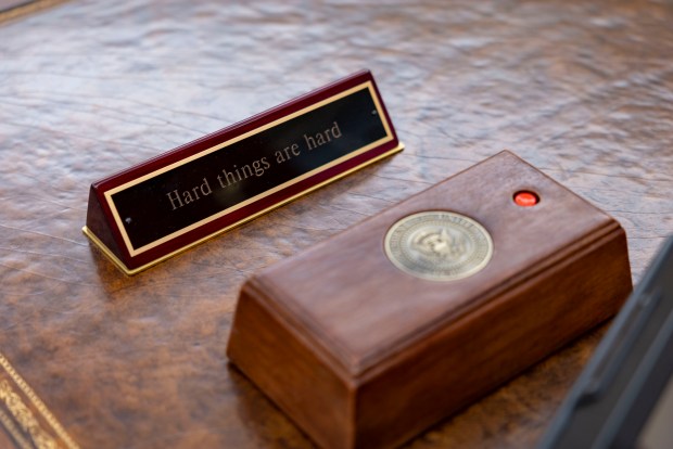 A sign is visible on a replica of the Resolute Desk in the Oval Office as the Obama Presidential Center prepares for opening, June 3, 2026, in Chicago's Jackson Park. (Brian Cassella/Chicago Tribune)