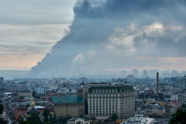 Smoke raises above the city in sunrise following a Russian air attack in Kyiv, Ukraine, Monday, June 15, 2026. (AP Photo/Efrem Lukatsky)