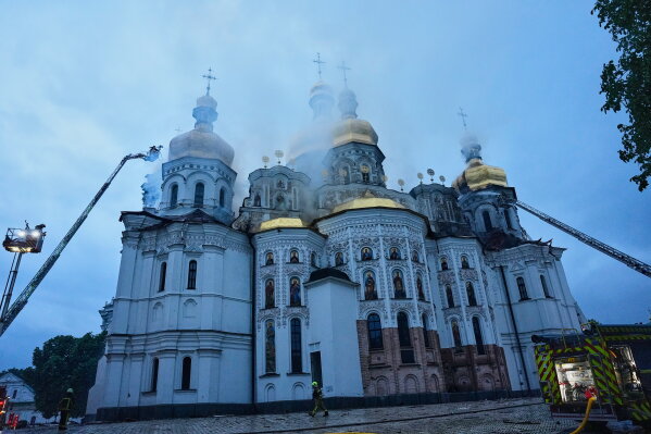 Rescue workers tries to put out a fire at the Kyiv-Pechersk Lavra, also known as the Monastery of the Caves, following a Russian strike in Kyiv, Ukraine, Monday, June 15, 2026. (AP Photo/Efrem Lukatsky)