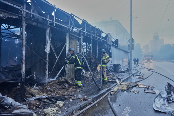 Firefighters put out a fire at a city marketplace following a Russian missile and drone attack in Kyiv, Ukraine, Monday, June 15, 2026. (AP Photo//Efrem Lukatsky)