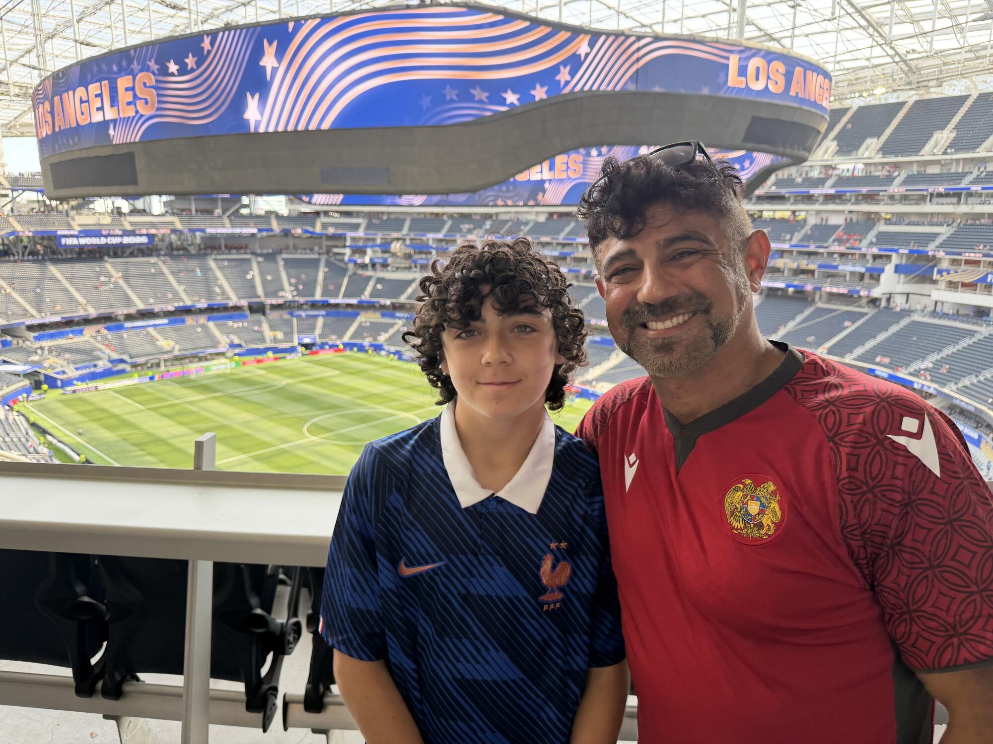 Narbé Mansourian, right, and his son Daniel before Monday's World Cup match between Iran and New Zealand at Sofi Stadium.