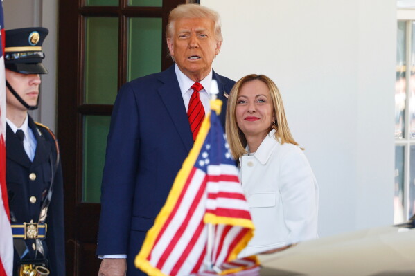 President Donald Trump, center, greets Italy's Prime Minister Giorgia Meloni, right, upon her arrival at the White House, April 17, 2025, in Washington. (AP Photo/Tom Brenner, File)