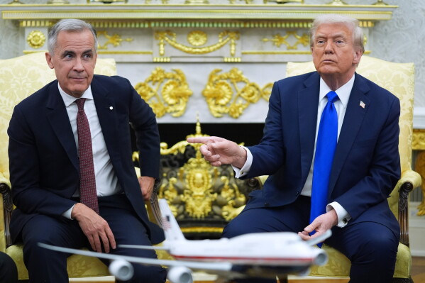President Donald Trump and Canadian Prime Minister Mark Carney meet in the Oval Office of the White House, Oct. 7, 2025, in Washington. (AP Photo/Evan Vucci, File)