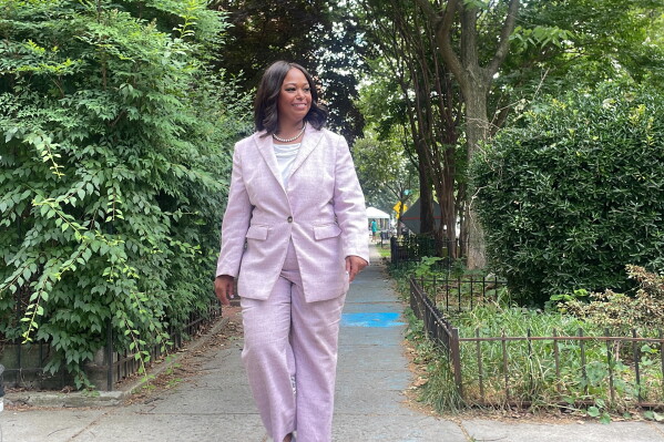 District of Columbia mayoral candidate Janeese Lewis George walks down a street while canvassing in a Washington, neighborhood, Monday, June 15, 2026. (AP Photo/Matt Brown)