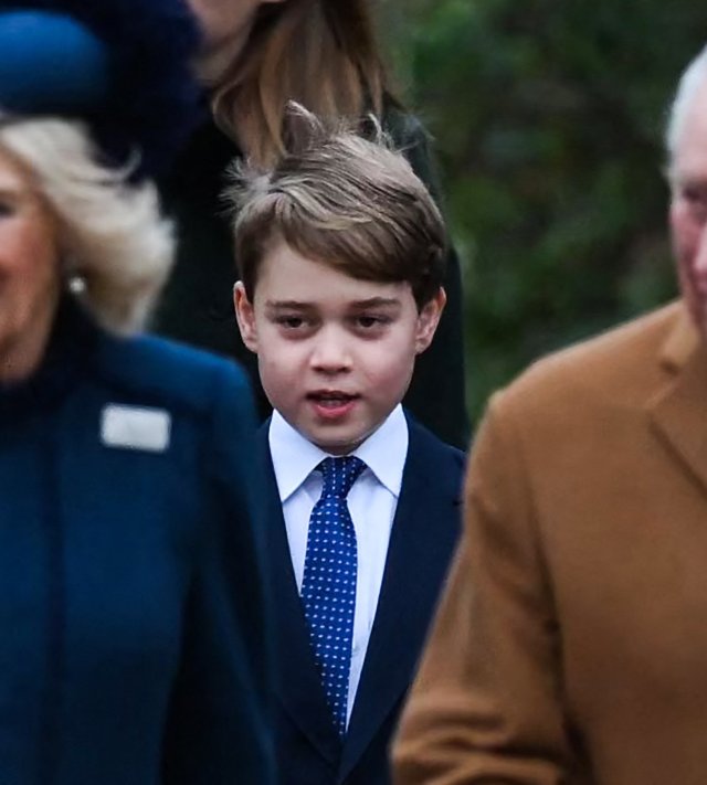 Britain's Prince George of Wales (C) walks behind Britain's Camilla, Queen Consort (L) and Britain's King Charles III as they arrive for the Royal Family's traditional Christmas Day service at St Mary Magdalene Church in Sandringham, Norfolk, eastern England, on December 25, 2022. (Photo by Daniel LEAL / AFP) (Photo by DANIEL LEAL/AFP via Getty Images)
