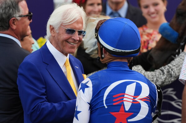 Flavien Prat, right, talks to trainer Bob Baffert after riding Nysos to victory in the Breeders' Cup Dirt Mile horse race, Saturday, Nov. 1, 2025, in Del Mar, Calif. (AP Photo/Gregory Bull, File)