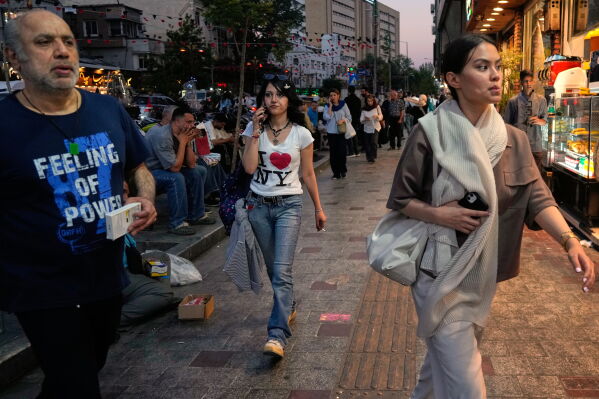 People walk along Tajrish square in northern Tehran, Monday, June 15, 2026. (AP Photo/Vahid Salemi)