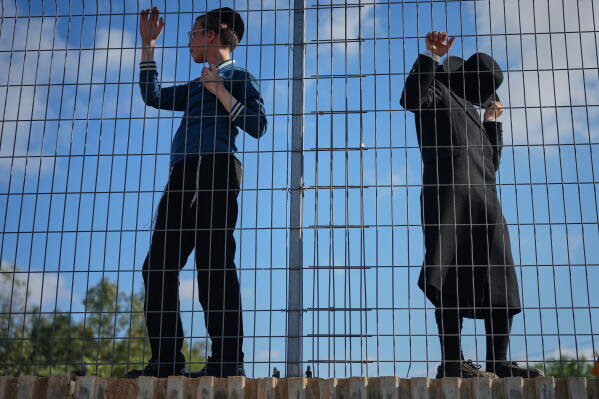 Ultra-Orthodox Jewish men protest against military recruitment and call for the release of detained draft resisters outside a military prison near Kfar Yona, Israel, Wednesday, June 17, 2026. (AP Photo/Ariel Schalit)