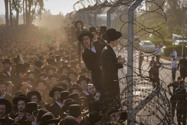Ultra-Orthodox Jewish men protest against military recruitment and call for the release of detained draft resisters outside a military prison near Kfar Yona, Israel, Wednesday, June 17, 2026. (AP Photo/Ariel Schalit)