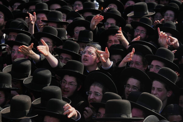 Ultra-Orthodox Jewish men protest against military recruitment and call for the release of detained draft resisters outside a military prison near Kfar Yona, Israel, Wednesday, June 17, 2026. (AP Photo/Ariel Schalit)