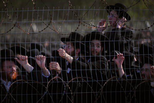 Ultra-Orthodox Jewish men protest against military recruitment and call for the release of detained draft resisters outside a military prison near Kfar Yona, Israel, Wednesday, June 17, 2026. (AP Photo/Ariel Schalit)