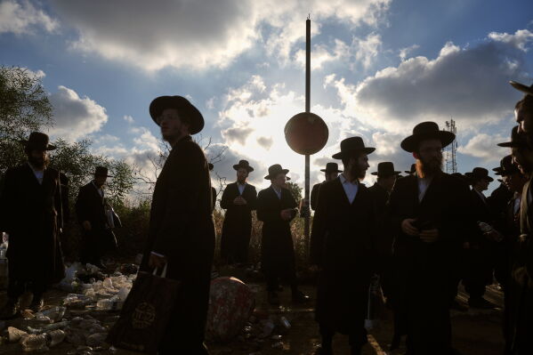 Ultra-Orthodox Jewish men protest against military recruitment and call for the release of detained draft resisters outside a military prison near Kfar Yona, Israel, Wednesday, June 17, 2026. (AP Photo/Ariel Schalit)