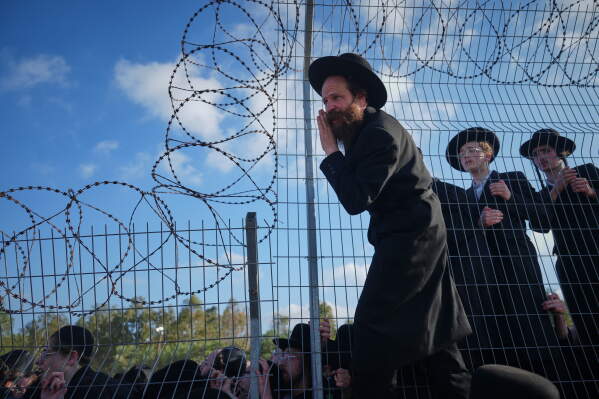 Ultra-Orthodox Jewish men protest against military recruitment and call for the release of detained draft resisters outside a military prison near Kfar Yona, Israel, Wednesday, June 17, 2026. (AP Photo/Ariel Schalit)
