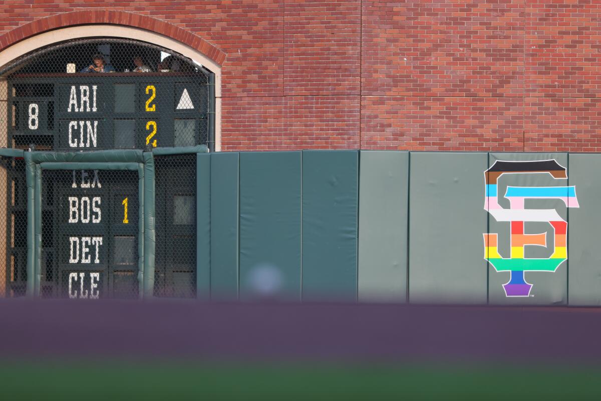 the San Francisco Giants pride logo in the outfield wall