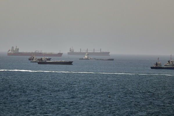 Tankers and cargo vessels are seen in the Gulf of Oman, along shipping routes linking the Strait of Hormuz and the Arabian Sea, Tuesday, June 16, 2026. (AP Photo)