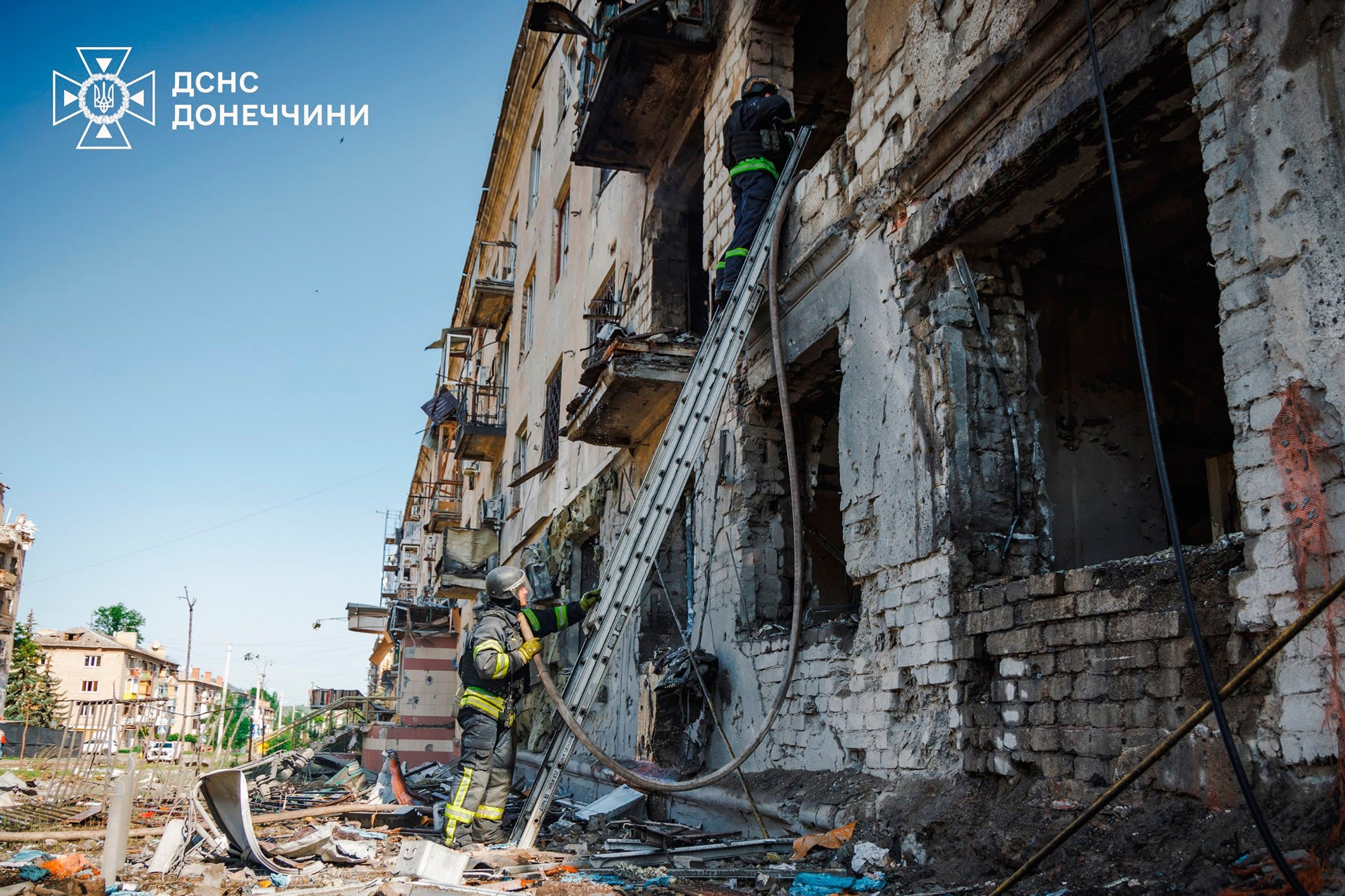 Emergency services personnel work to extinguish a fire after a Russian air attack in Kramatorsk
