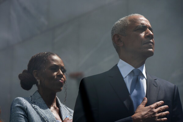 Former President Barack Obama and former First Lady Michelle Obama on stage during the dedication ceremony for the Obama Presidential Center, Thursday, June 18, 2026, in Chicago. (AP Photo/Alex Brandon)