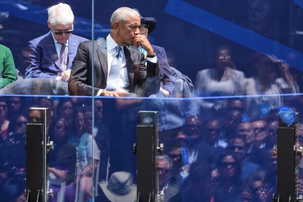 Former President Barack Obama gets emotional as his wife, former first lady Michelle Obama, speaks during the dedication ceremony for the Obama Presidential Center, Thursday, June 18, 2026, in Chicago. (AP Photo/Jeff Roberson)