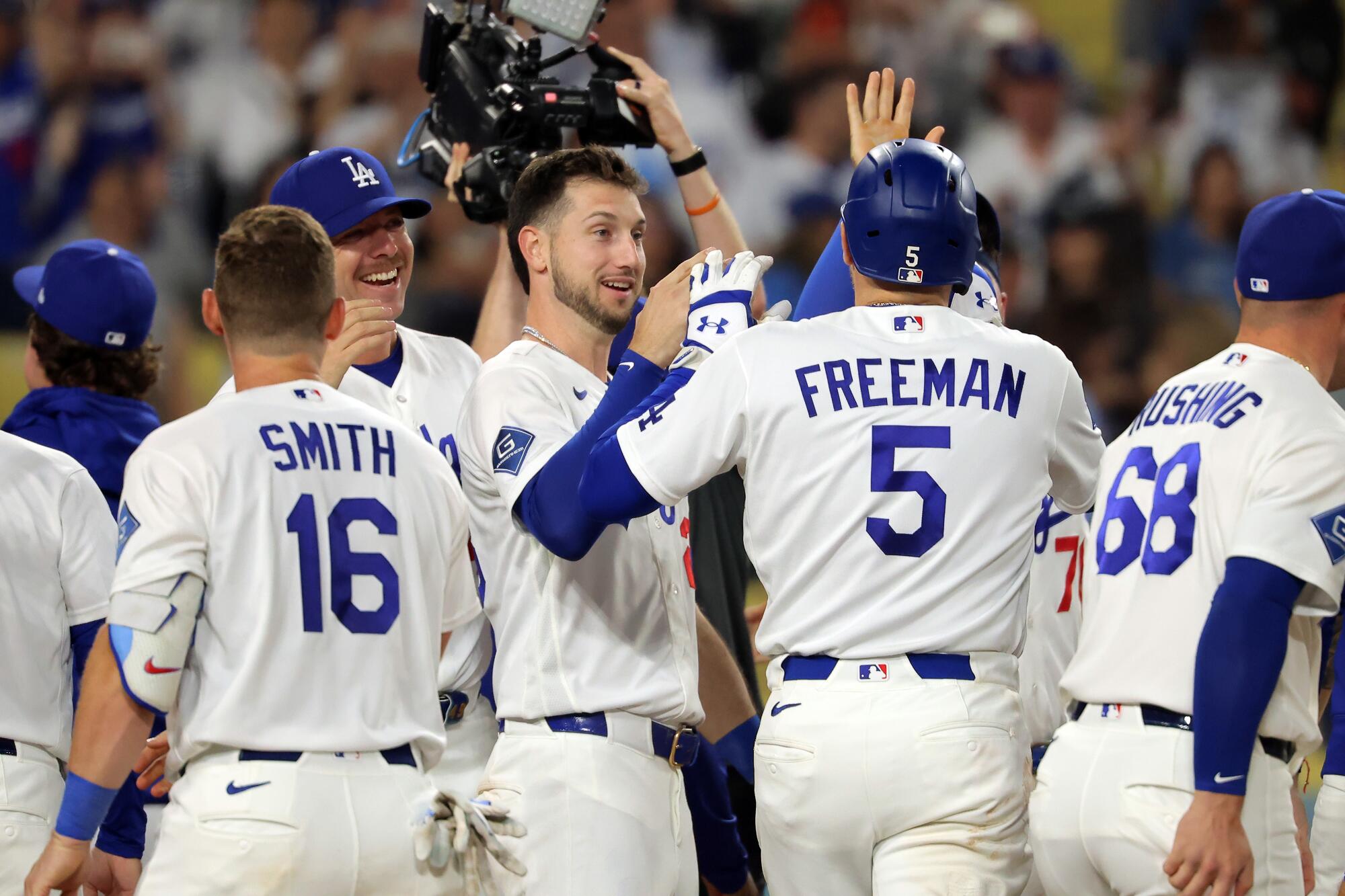 Dodgers teammates congratulate Freddie Freeman after his walk-off home run.