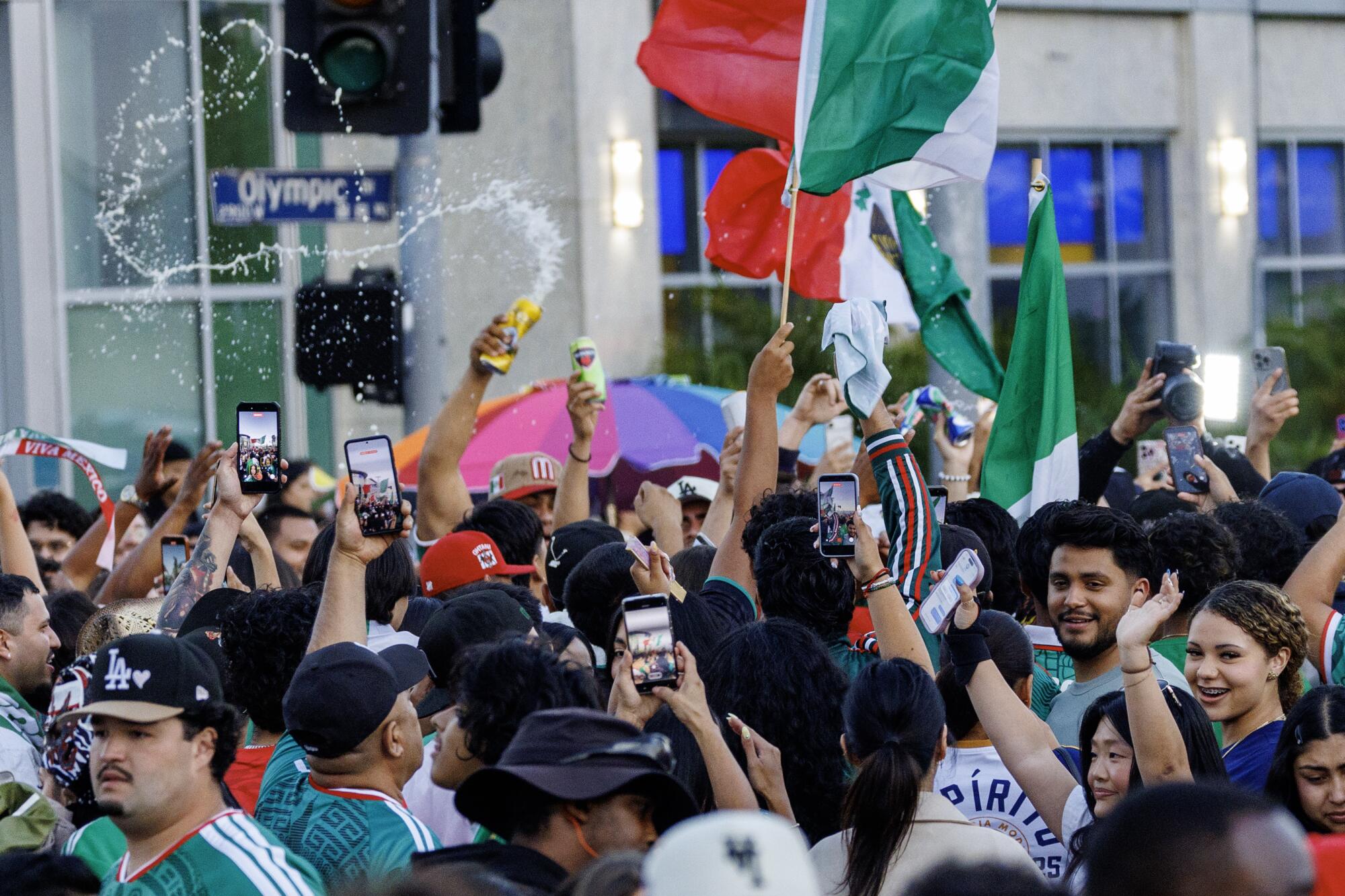 Fans fill the streets at Olympic and Normandie following a watch party for the World Cup match Mexico vs Korea.