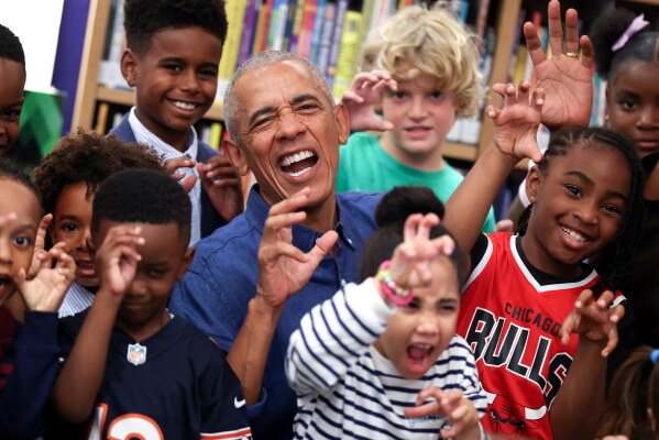 Former President Barack Obama poses for a photograph after reading to school children on opening day of the Barack Obama Presidential Center in John Lewis Plaza, Friday, June 19, 2026, in Chicago. (Win McNamee/Pool Photo via AP)