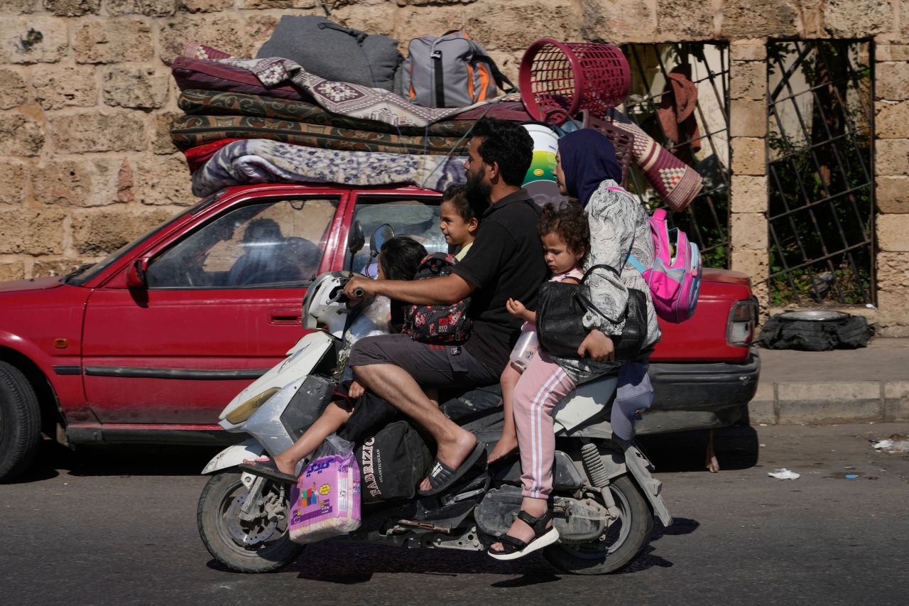 A displaced family fleeing Israeli strikes drives on a highway in the southern port city of Sidon, Lebanon on Friday.