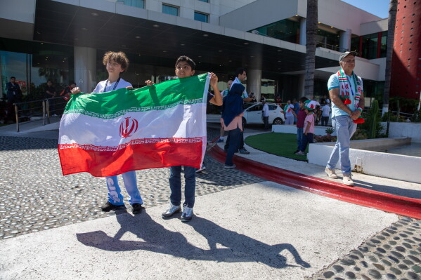 Children cheer for the Iran national soccer team as they depart from the Tijuana Marriott in Tijuana, Mexico on Saturday June 20, 2026. (AP Photo/Gabriela Aoun Angueira)