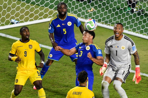 Curaçao's Jurien Gaari (3) heads the ball away on a corner kick as Ecuador's John Yeboah (9) and Curaçao goalkeeper Eloy Room (1) and Sherel Floranus (5) look on during the World Cup Group E soccer match between Ecuador and Curacao in Kansas City, Mo., Saturday, June 20, 2026. (AP Photo/Reed Hoffmann)