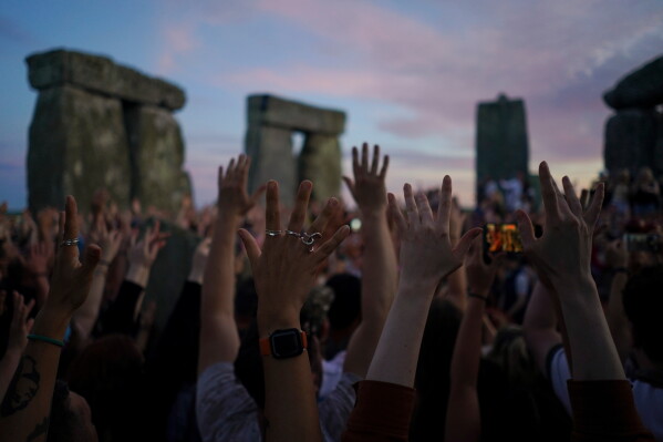 Revelers gather at the ancient stone circle Stonehenge to celebrate the summer solstice, the longest day of the year, near Salisbury, England, Saturday, June 20, 2026. (AP Photo/Alberto Pezzali)