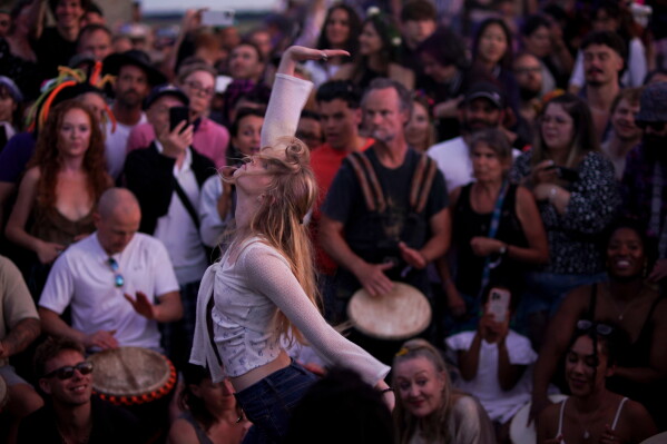 Revelers gather at the ancient stone circle Stonehenge to celebrate the summer solstice, the longest day of the year, near Salisbury, England, Saturday, June 20, 2026. (AP Photo/Alberto Pezzali)