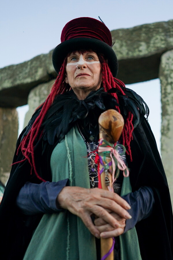 A reveler at the ancient stone circle Stonehenge to celebrate the summer solstice, the longest day of the year, near Salisbury, England, on Saturday, June 20, 2026. (AP Photo/Alberto Pezzali)