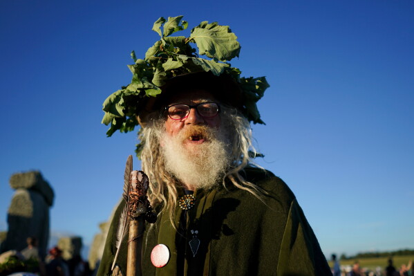 A reveller at the ancient stone circle Stonehenge to celebrate the summer solstice, the longest day of the year, near Salisbury, England, on Saturday, June 20, 2026. (AP Photo/Alberto Pezzali)