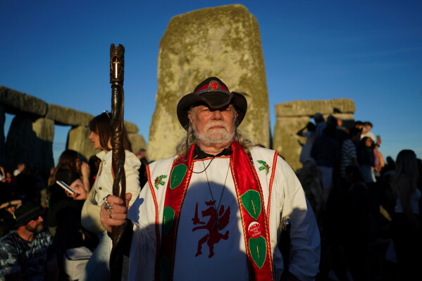 A reveler at the ancient stone circle Stonehenge to celebrate the summer solstice, the longest day of the year, near Salisbury, England, on Saturday, June 20, 2026. (AP Photo/Alberto Pezzali)