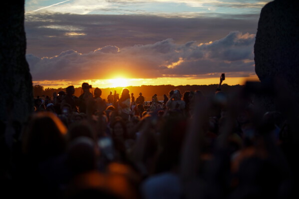 Revelers gather at the ancient stone circle Stonehenge to celebrate the summer solstice, the longest day of the year, near Salisbury, England, Saturday, June 20, 2026. (AP Photo/Alberto Pezzali)