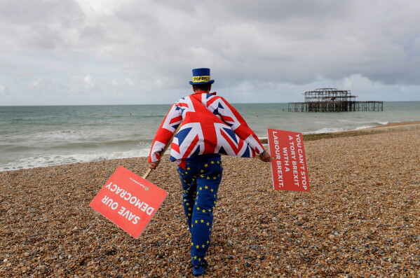 FILE- Anti Brexit campaigner Steve Bray walks on the beach to pose for a photograph during the Labour Party Conference at the Brighton Centre in Brighton, England, Monday, Sept. 23, 2019. (AP Photo/Kirsty Wigglesworth, File)