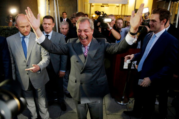 Nigel Farage, the leader of the UK Independence Party, celebrates and poses for photographers as he leaves a "Leave.EU" organization party for the British European Union membership referendum in London., June 24, 2016. (AP Photo/Matt Dunham, File)