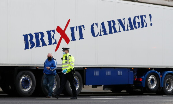 A policeman escorts the driver of a shellfish export truck as he is stopped for an unnecessary journey in London, Monday, Jan, 18, 2021. (AP Photo/Alastair Grant, File)