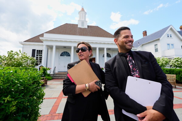 Wedding planners Nicole Simeral and Carlo Monti oversee a wedding at the Watch Hill Chapel, near Taylor Swift's house, Saturday, June 20, 2026, in Westerly, R.I. (AP Photo/Robert F. Bukaty)