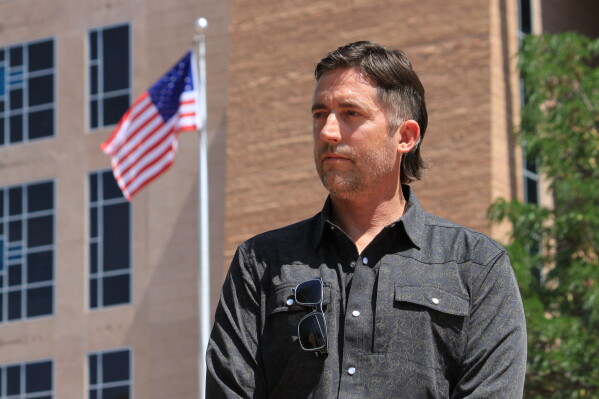 DEA Special Agent David Howell, who filed a whistleblower complaint, poses for a portrait outside the U.S. district courthouse in Albuquerque, N.M., on Friday, June 12, 2026. (AP Photo/Susan Montoya Bryan)