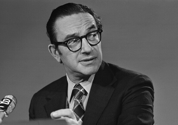 Alan Greenspan chairman of the Council of Economic Advisers, chats with newsmen prior to his appearance on NBC's "Meet the Press", Sept. 29, 1974, in Washington. (AP Photo/Bob Daugherty, file)
