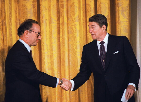 President Reagan congratulates Alan Greenspan after he was sworn-in as new chairman of the Federal Reserve Board during a ceremony at the White House in this Aug. 11, 1987. (AP Photo/Barry Thumma, file)
