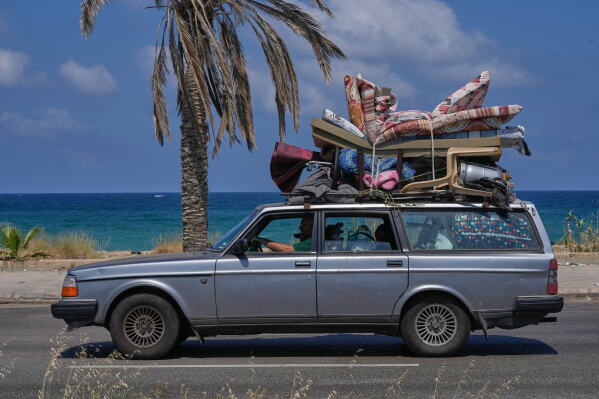 A displaced family with their belongings, return to their village following a ceasefire between Israel and Hezbollah in the southern port city of Sidon, Lebanon, Tuesday, June 23, 2026. (AP Photo/Mohammed Zaatari)